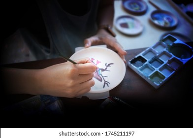 Professional female potter examining paint ceramic  with handle in workshop, studio. Handmade, small business, crafting work concept - Powered by Shutterstock