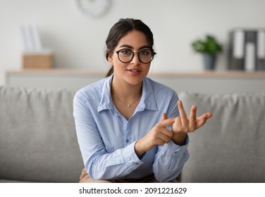 Professional Female Psychologist Talking To Camera And Gesturing During Therapy Session At Clinic. Young Middle Eastern Psychotherapist Working At Office