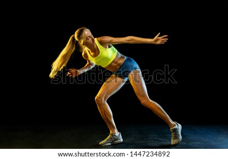 Similar – One young middle age athletic woman at crossfit training, exercising with trx suspension fitness straps over dark background, front view, looking up