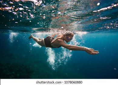 Professional Female Swimmer Swim In The Ocean On The Sunrise, Underwater Picture