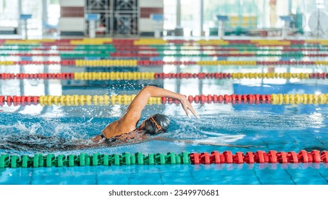 Professional female swimmer swimming the front crawl stroke. Freestyle competition concept. - Powered by Shutterstock