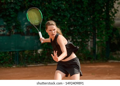 Professional female tennis player running to hit a ball. Agility and full concentration. Women in sports. - Powered by Shutterstock