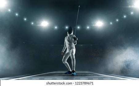 Professional Fencer In Fencing Mask With Rapier