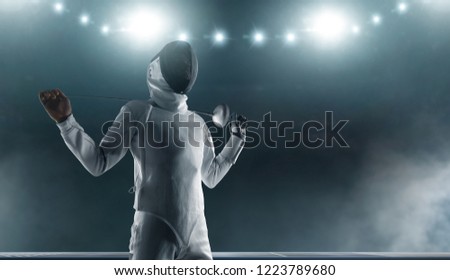 Professional fencer in fencing mask with rapier