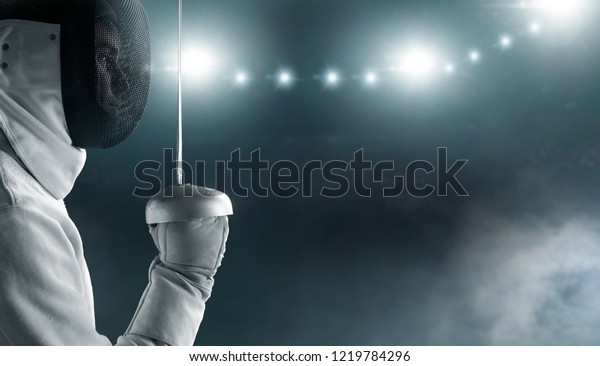 Professional fencer in
fencing mask with
rapier