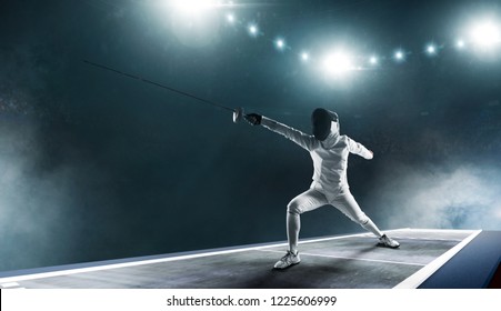 Professional Fencer Girl In Fencing Mask With Rapier