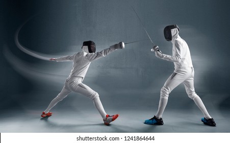 Professional Fencers In Fencing Mask With Rapier