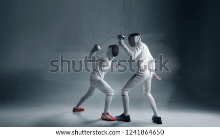Professional fencers in fencing mask with rapier