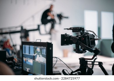 A professional film and video camera on the set. Filming day, equipment and crew. Technique of modern video filming. - Shutterstock ID 2284725977