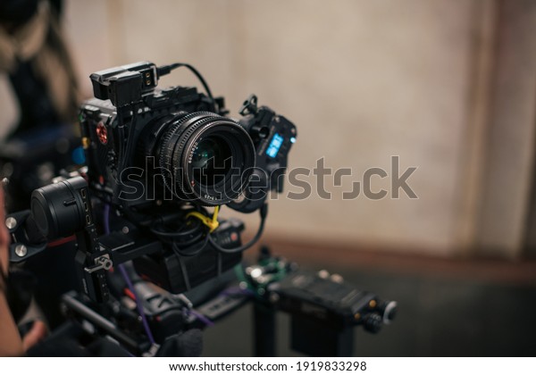 Professional film\
and video camera on the set. Shooting shift, equipment and group.\
Modern photography\
technique.