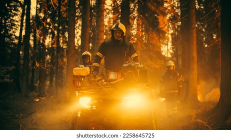 Professional Firefighters Crew Walking and Riding an ATV in Forest, Controlling a Wildland Fire Before it Becomes a Catastrophic Event. First Responders Arrive to the Forest and Assess the Situation. - Shutterstock ID 2258645725
