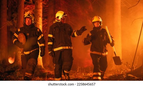 Professional Firefighters Crew Walking in a Smoke-Filled Forest, Controlling a Wildland Fire Before it Spreads. Team of Three First Responders Stay Calm and Receive Orders from Superintendent. - Shutterstock ID 2258645657