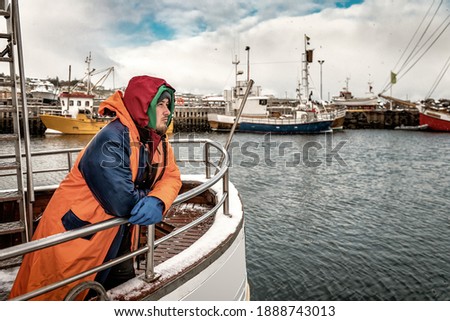 Professional fisherman in winter scandinavian port