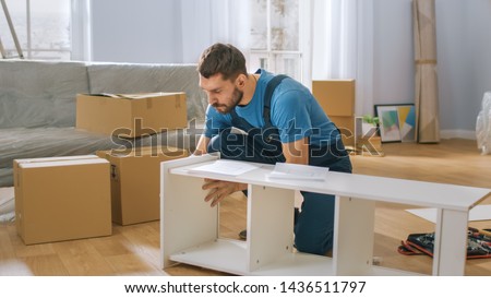 Professional Furniture Assembly Worker Assembles Shelf. Professional Handyman Doing Assembly Job Well, Helping People who Move into New House.