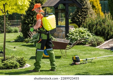 Professional Gardener with Pump Sprayer Attached to His Back Performing Seasonal Garden and Lawn Pest-Control Spraying. - Powered by Shutterstock