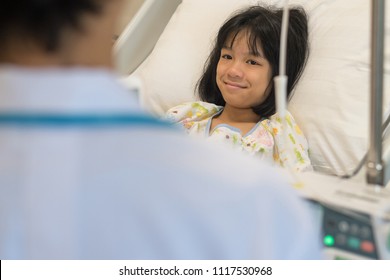 Professional general medical pediatrician doctor checkup Asia child patient in inpatient (IPD) ward. Physician check up Asian kid female in hospital room. - Powered by Shutterstock