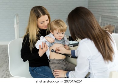 Professional General Medical Pediatrician Doctor In White Uniform Gown Listen Lung And Heart Sound Of Child Patient With Stethoscope: Physician Check Up Kid Female After Consult In Hospital