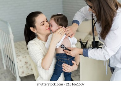 Professional General Medical Pediatrician Doctor In White Uniform Gown Listen Lung And Heart Sound Of Child Patient With Stethoscope: Physician Check Up Kid Female After Consult In Hospital