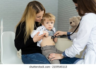 Professional General Medical Pediatrician Doctor In White Uniform Gown Listen Lung And Heart Sound Of Child Patient With Stethoscope: Physician Check Up Kid Female After Consult In Hospital