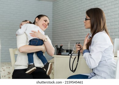 Professional General Medical Pediatrician Doctor In White Uniform Gown Listen Lung And Heart Sound Of Child Patient With Stethoscope: Physician Check Up Kid Female After Consult In Hospital