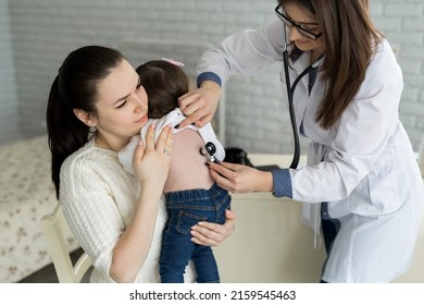 Professional General Medical Pediatrician Doctor In White Uniform Gown Listen Lung And Heart Sound Of Child Patient With Stethoscope: Physician Check Up Kid Female After Consult In Hospital