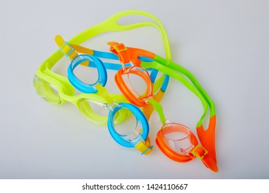 Professional Glasses For Swimming Isolated On A White Background. Kid's And Adult Pool Goggles.