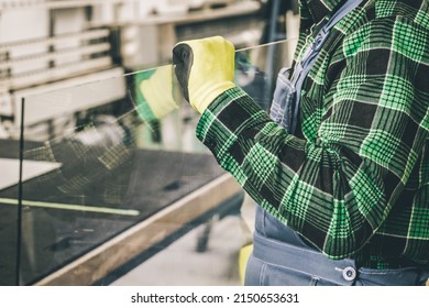 Professional Glazier Holds A Large Glass In His Hands, Glass-making Plant, Specialist Work 