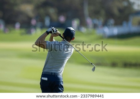 professional golf player hitting the ball. backswing