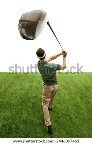 Professional golfer in retro outfit in mid follow-through with focus on club, green turf against white studio background. Concept of professional sport, luxury games, active lifestyle, action. Ad