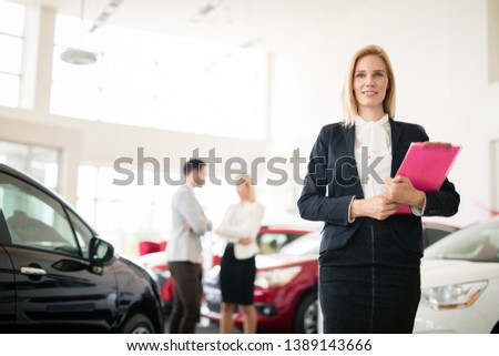Professional gorgeous saleswoman at car dealership in formal wear. Super consultant and manager