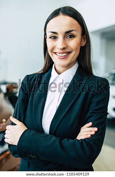 Professional gorgeous saleswoman at\
car dealership in formal wear. Super consultant or\
manager