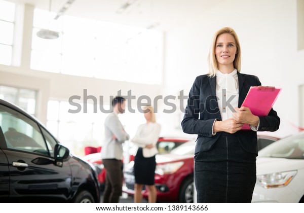 Professional gorgeous saleswoman\
at car dealership in formal wear. Super consultant and\
manager