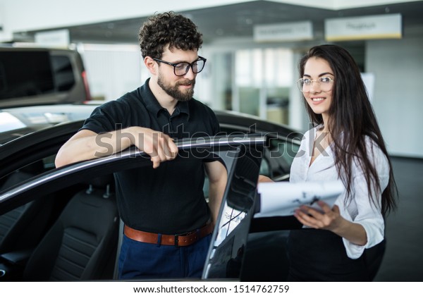 Professional gorgeous saleswoman\
at car dealership in formal wear. Super consultant and\
manager