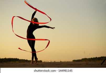 Professional Gymnast Woman Dancer Posing With Ribbon