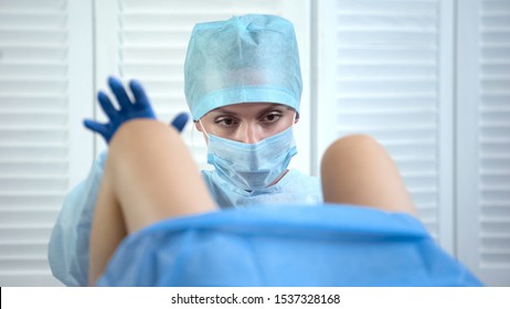 Professional Gynecologist Taking Womans Cervix Sample During Examination