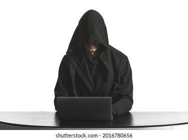 Professional hacker using laptop at table against white background