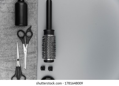 Professional Hair Dresser Tools With Copy Space. Hair Stylist Equipment Set On Gray Background. Scissors, Brush, Hairbrush, Balm Flat Lay Top View.