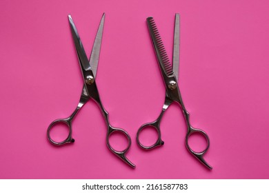 Professional Hair Dresser Tools On Pink Background With Copy Space. Hair Stylist Equipment Set. Scissors Flat Lay Top View.