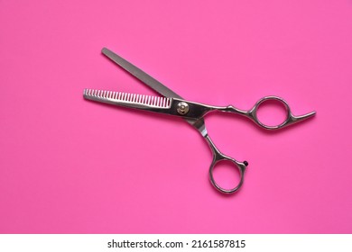 Professional Hair Dresser Tools On Pink Background With Copy Space. Hair Stylist Equipment Set. Scissors Flat Lay Top View.