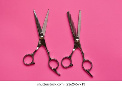 Professional Hair Dresser Tools On Pink Background With Copy Space. Hair Stylist Equipment Set. Scissors Flat Lay Top View.