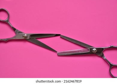 Professional Hair Dresser Tools On Pink Background With Copy Space. Hair Stylist Equipment Set. Scissors Flat Lay Top View.