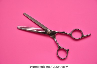 Professional Hair Dresser Tools On Pink Background With Copy Space. Hair Stylist Equipment Set. Scissors Flat Lay Top View.