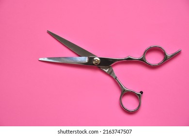 Professional Hair Dresser Tools On Pink Background With Copy Space. Hair Stylist Equipment Set. Scissors Flat Lay Top View.