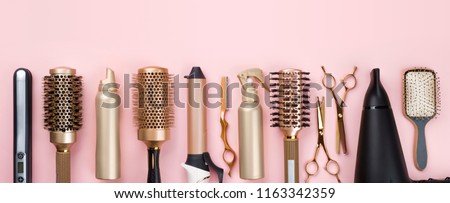 Professional hair dresser tools on pink background with copy space