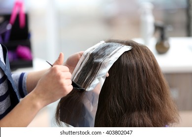 Professional hairdresser coloring hair - Powered by Shutterstock