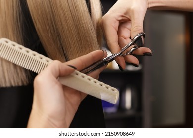 Professional hairdresser cutting woman's hair in salon, closeup - Shutterstock ID 2150908649