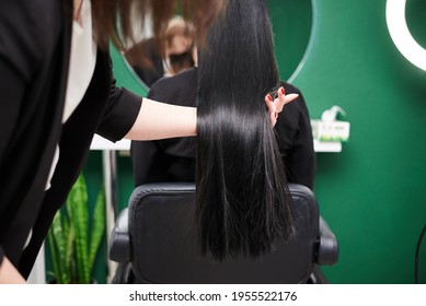 Professional Hairdresser Making Hairstyling For Female Client In Front Of Mirror. Close-up Picture Of Work Process In Barber Shop. Young Brunette Woman Getting Ready For Party