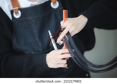 professional hairdresser person doing haircut for woman client in beauty fashion salon, hair care coiffure style concept, beautician female work with cut scissors to comb in barber, hairstylist tool
