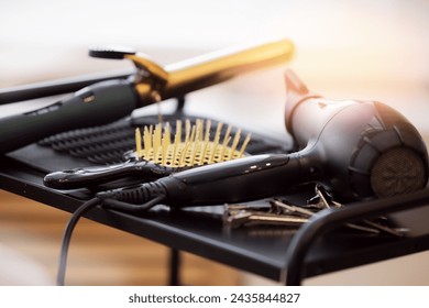 Professional hairdresser set tools for beauty hair care, hairstyle banner. Dryer, curling iron and comb on salon with sunlight background. - Powered by Shutterstock