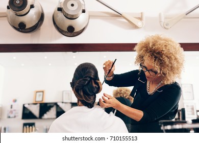 Professional Hairdresser Styling The Hair Of A Customer At Salon. Female Hair Stylist Setting Hair In Fashionable Design.